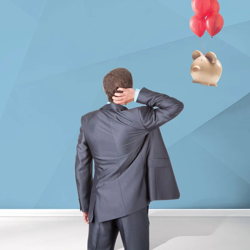 A man in a suit stands with his back to the viewer, scratching his head, looking at a piggy bank floating with red balloons on a light blue geometric background. Text on the left reads ‘Claim Assist’ followed by ‘Let us focus on the claims investigation so you can focus on the day job.’