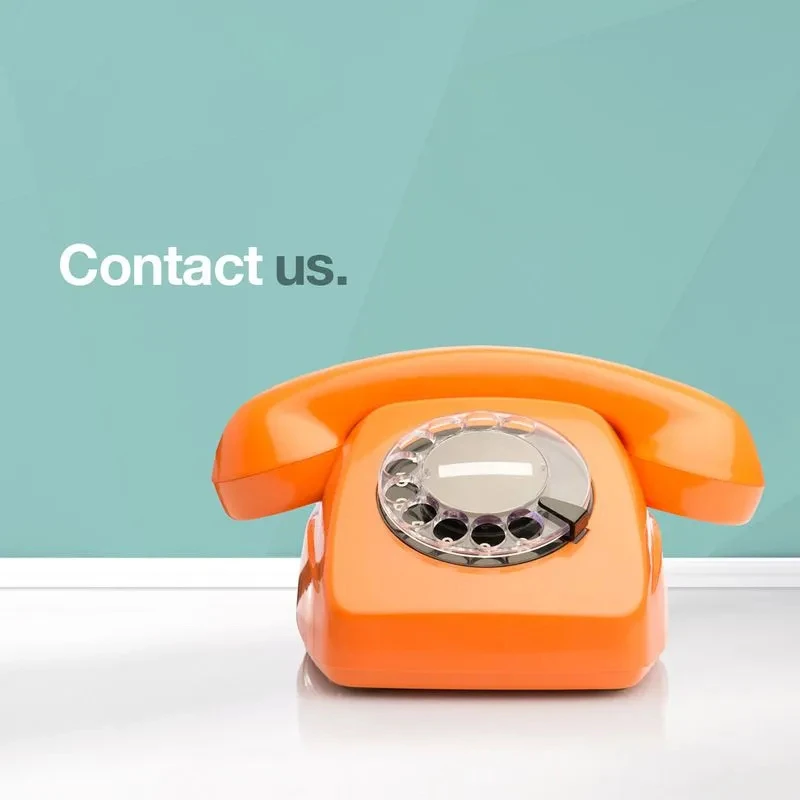 An orange rotary phone sits prominently against a teal geometric background, symbolising communication. The QURE logo with the tagline ‘Problem Solved’ is displayed on the left, while the text ‘Contact us.’ appears on the right.